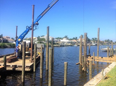 Picture showing a barge installing pilings in the water