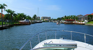 Picture showing a Boat going through a Cape Coral canal
