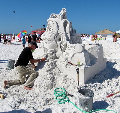 Picture showing an artist working on his creation at the Sandsculpting Championships in Fort Myers Beach
