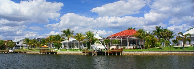 Picture showing finished homes at a Cape Coral canal from the back with installed boat docks