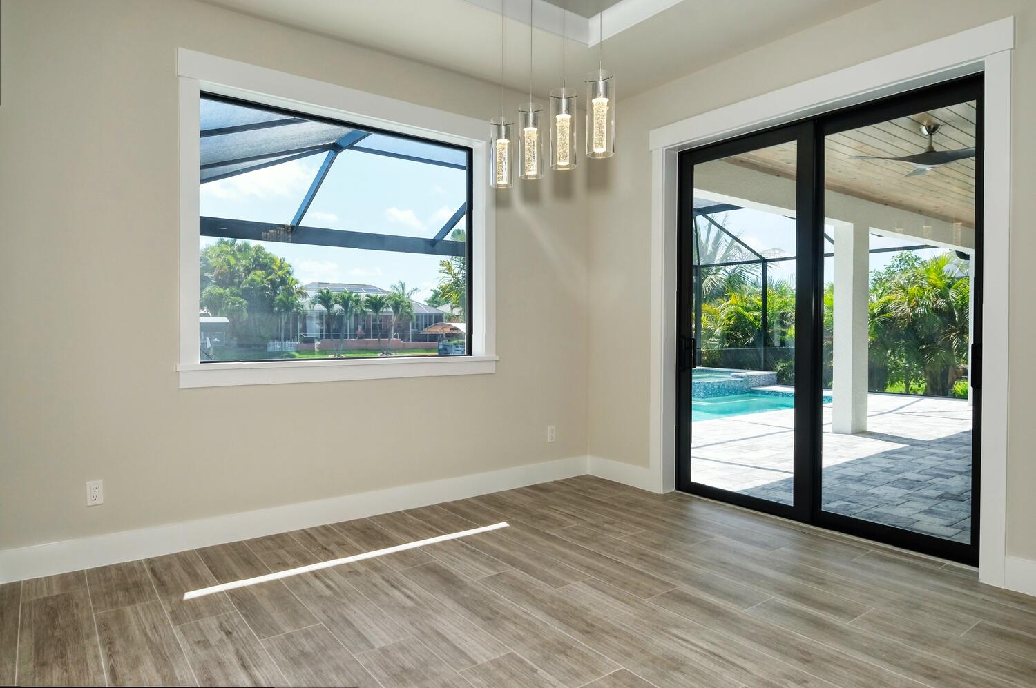 Picture of the dining area with pool view of the model home Serenity