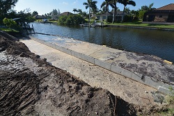 Picture showing the installed seawall concrete panels in the canal at the back property line