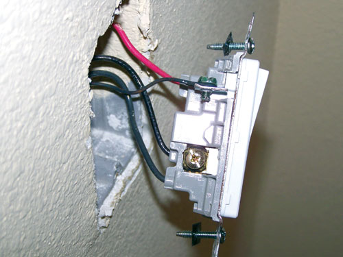 Picture of an open power receptacle during an inspection for Chinese drywall